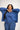 Woman wearing a blue outfit with a white background